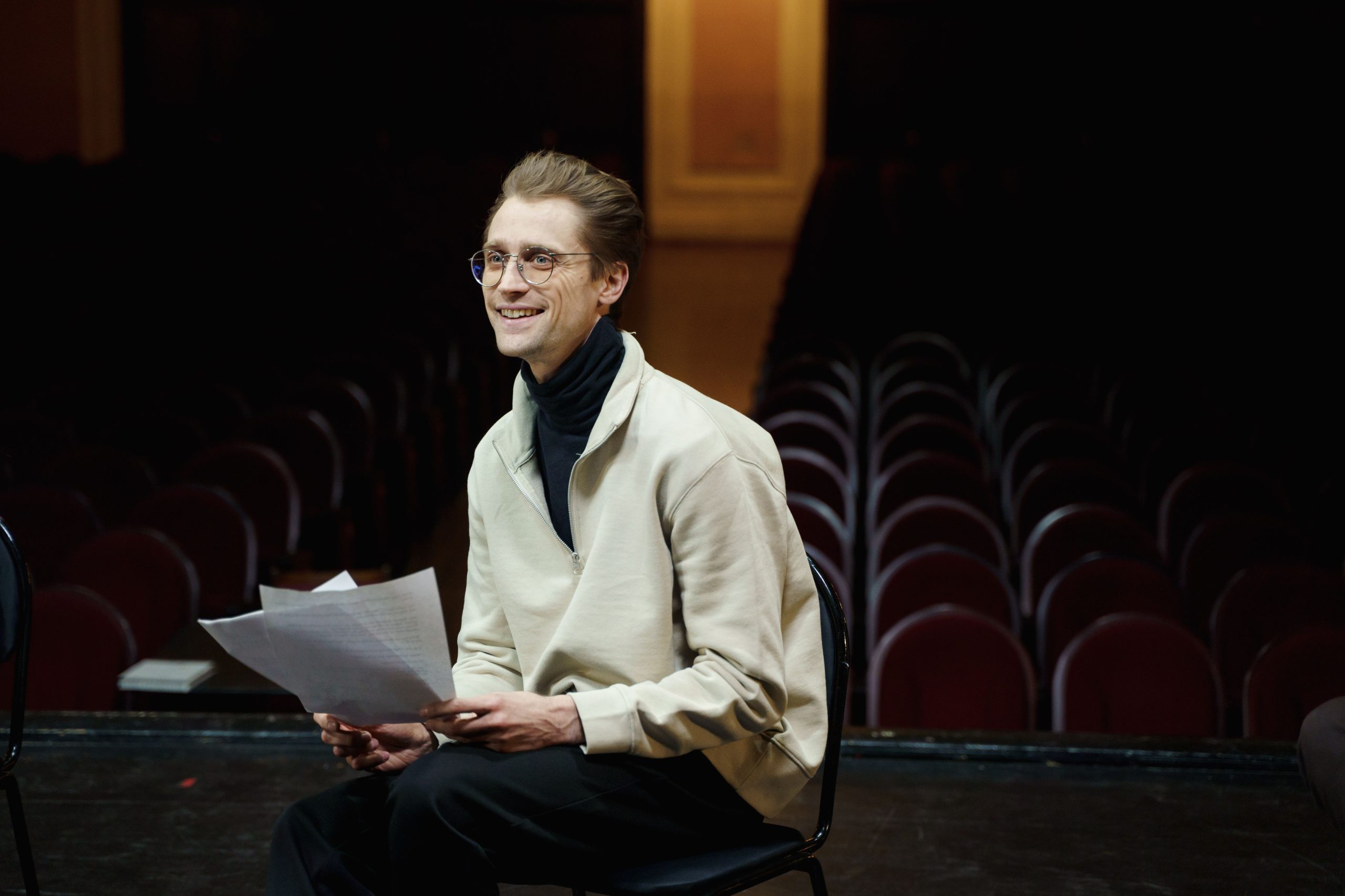 Aspiring actor working on career goals inside a theatre.