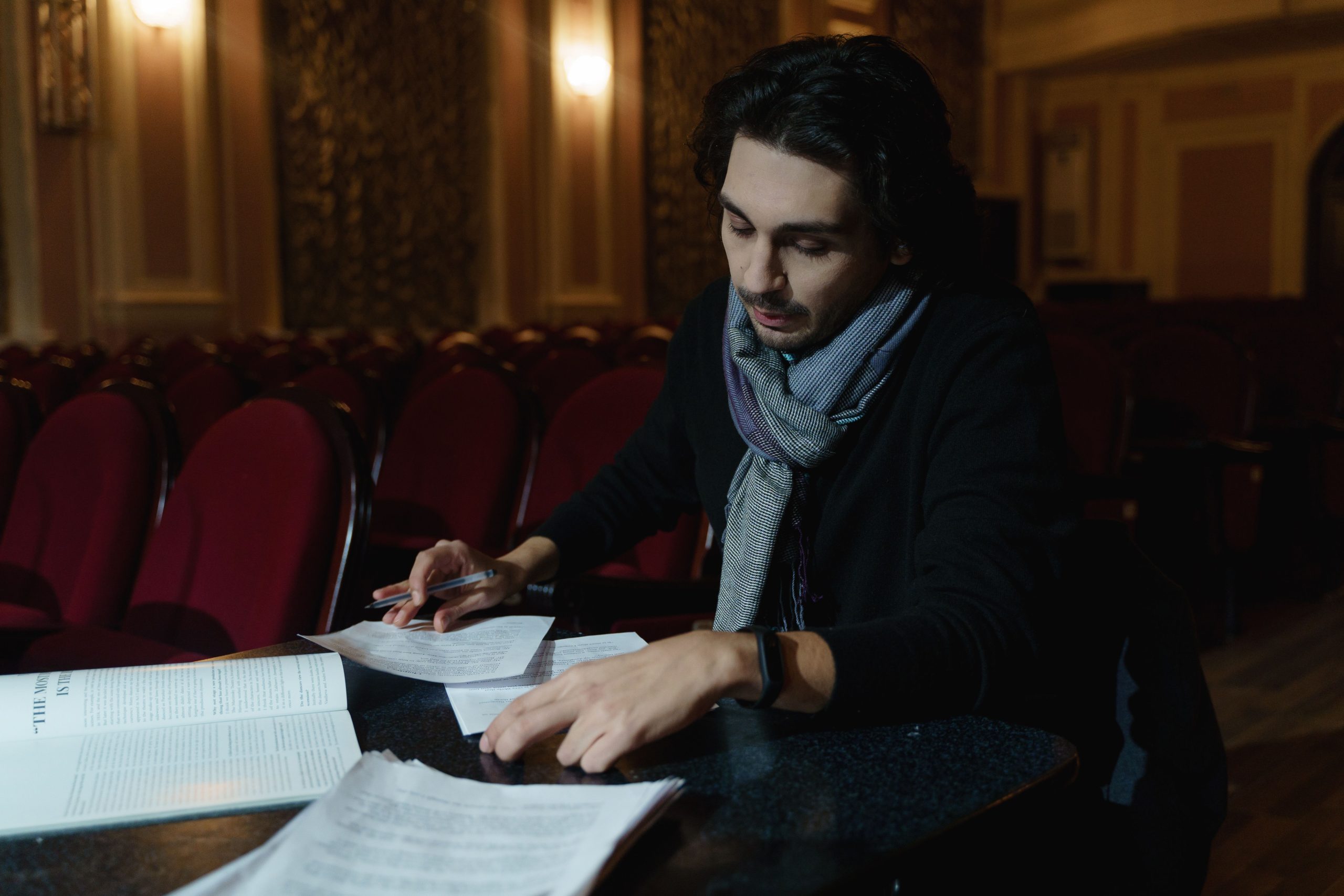Actor reviewing a script while preparing for a role.