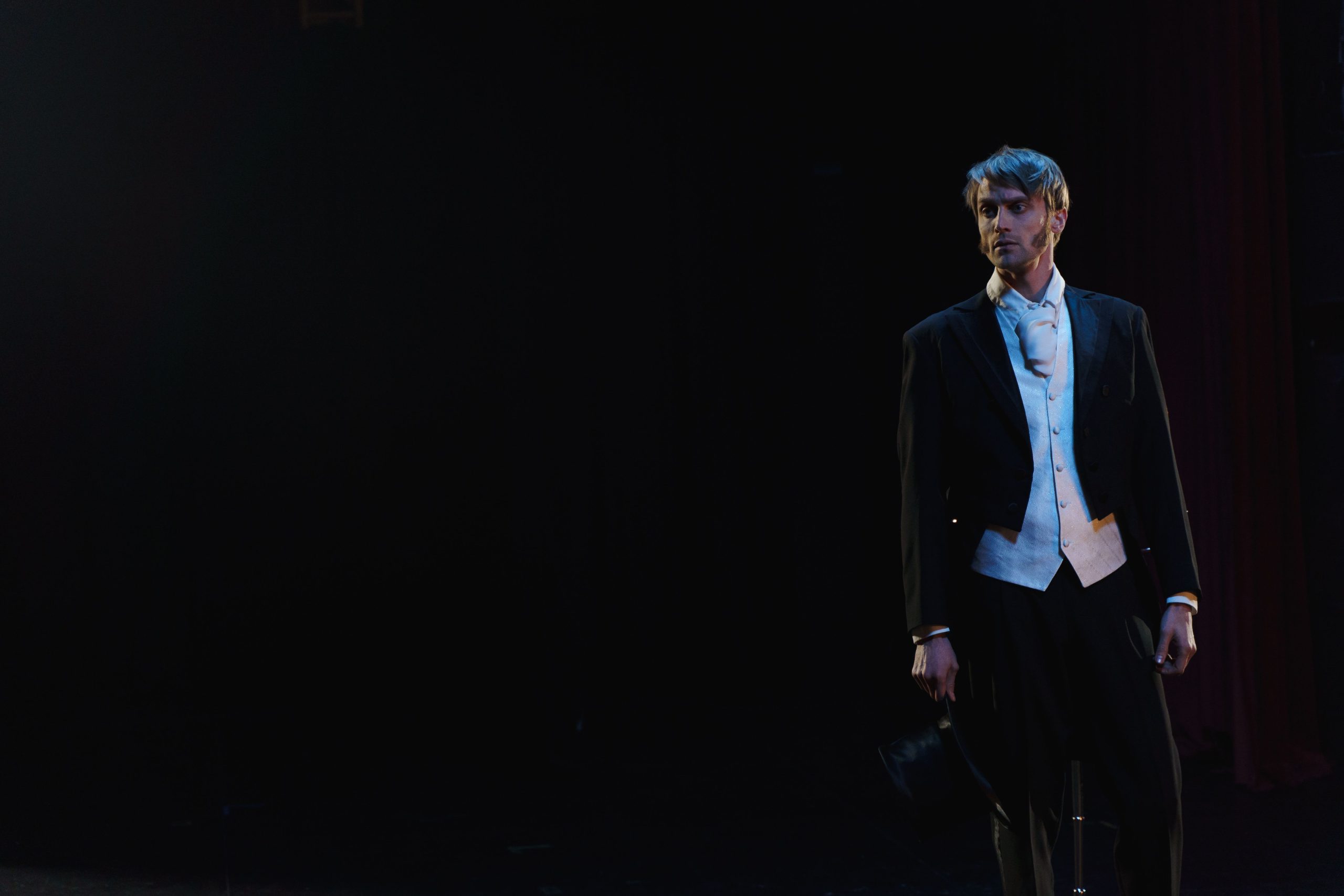 Anxious actor standing on stage and preparing to perform despite feeling nervous under pressure.